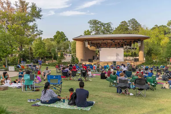 Families on the lawn at Downtown Cary Park on a summer evening
