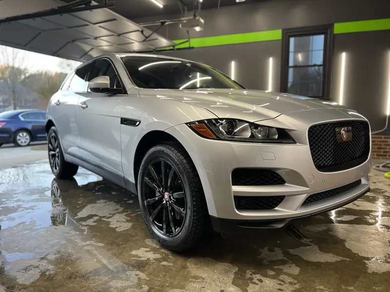 Silver Jaguar F-Pace in the studio after a full detail, floor still wet