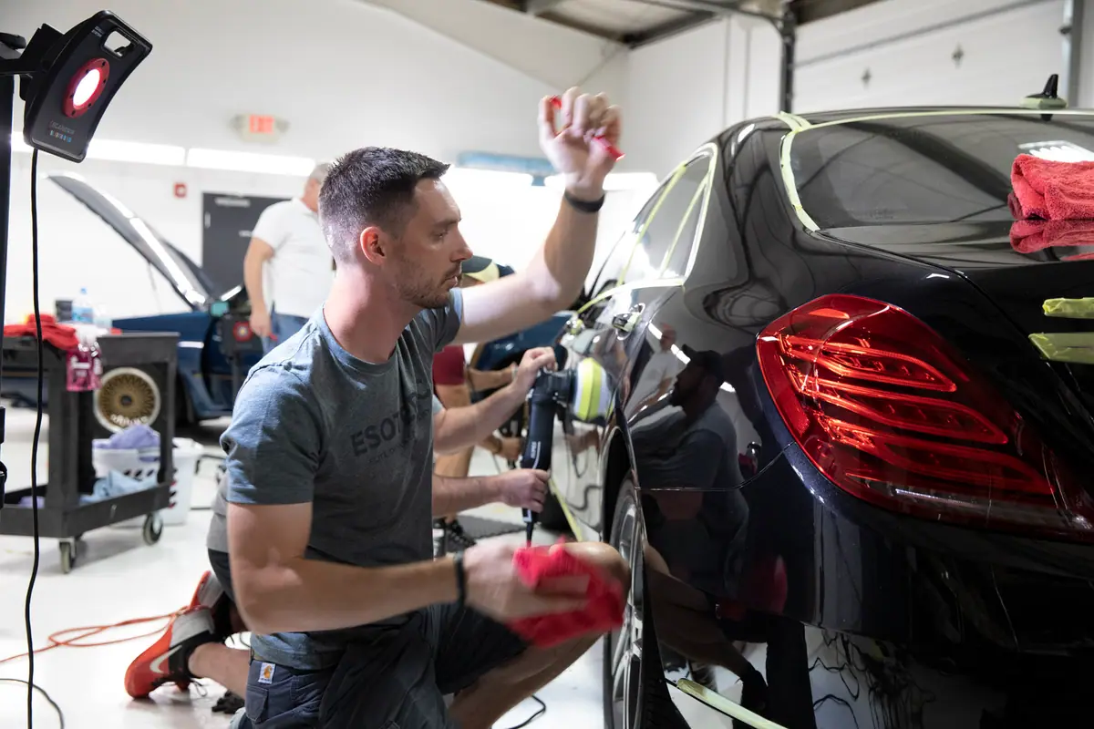 Jeff Miller working a rear quarter panel with a polisher at Esoteric