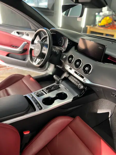 Kia Stinger center console and red leather seats after detailing